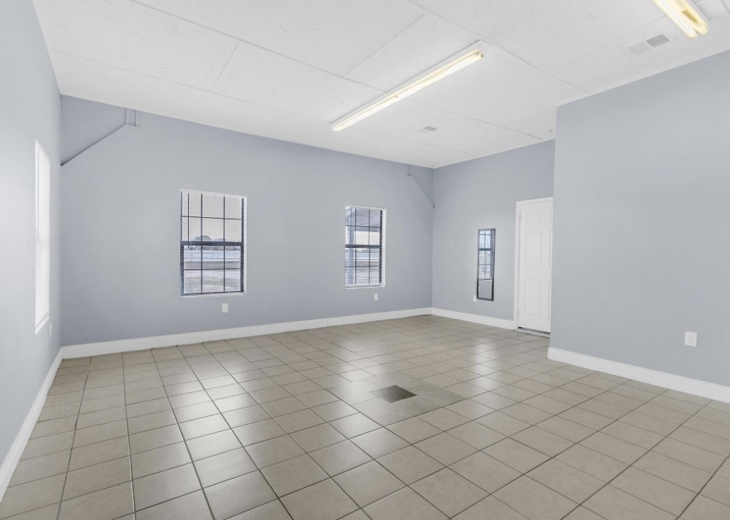 9678 Interstate 10 Frontage Road, Unit 1 Sealy, TX 77474 - Photo 10 of 19 an empty room with windows