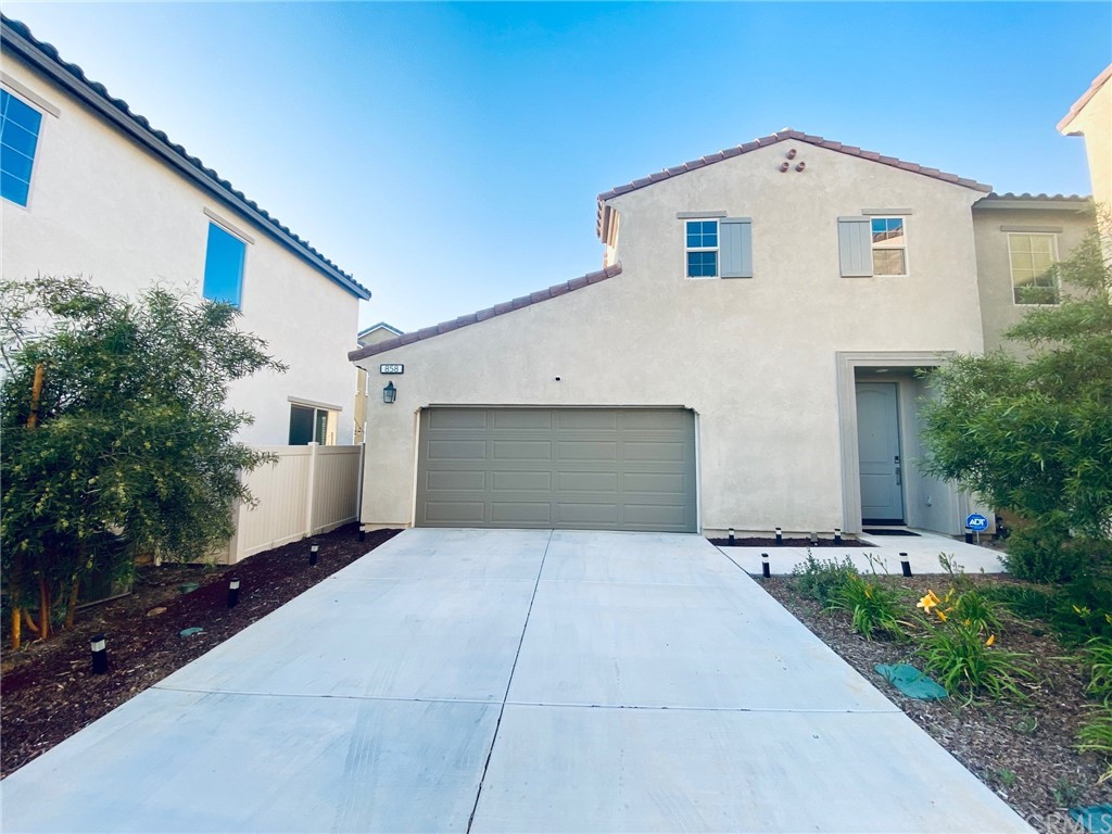 858 Blue Orchid Beaumont, CA 92223 - Photo 1 of 33 a front view of a house with yard and trees
