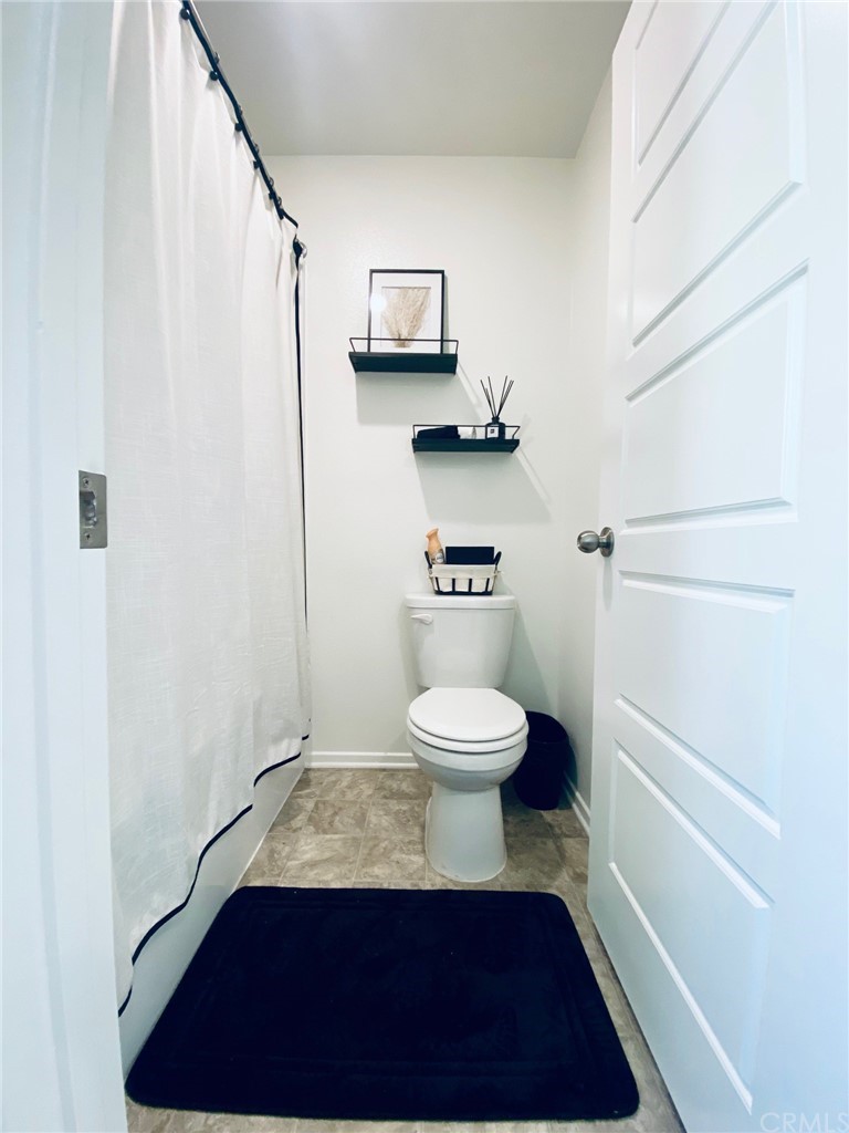 858 Blue Orchid Beaumont, CA 92223 - Photo 17 of 33 a bathroom with a toilet and a shower