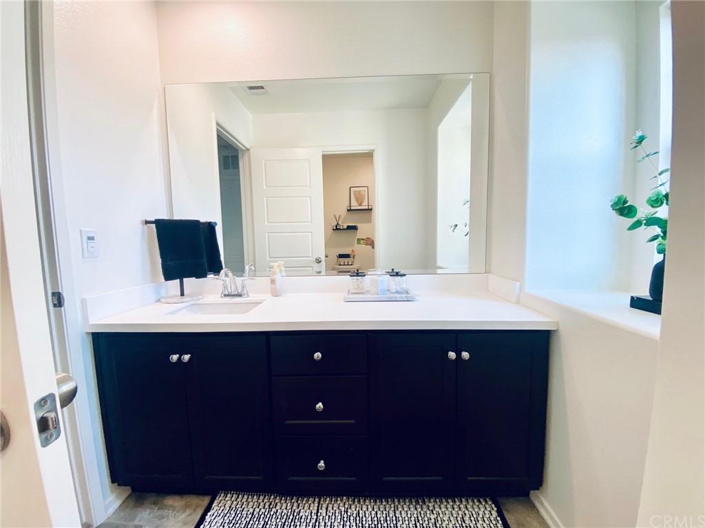 858 Blue Orchid Beaumont, CA 92223 - Photo 18 of 33 a bathroom with a sink and a mirror