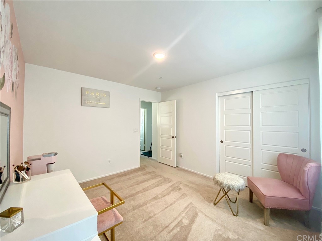 858 Blue Orchid Beaumont, CA 92223 - Photo 20 of 33 a bedroom with a bed and a couch