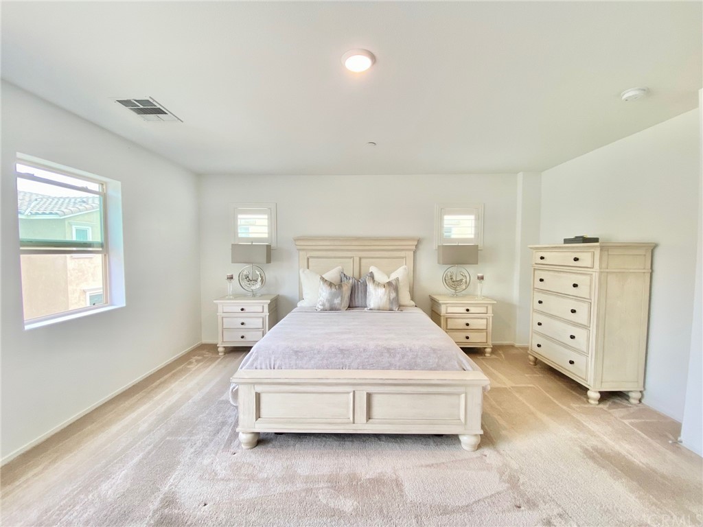 858 Blue Orchid Beaumont, CA 92223 - Photo 21 of 33 a bedroom with a bed and window