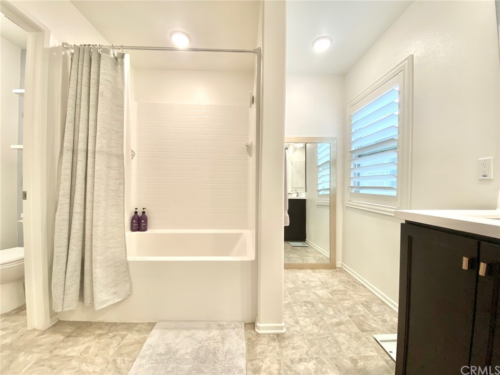 858 Blue Orchid Beaumont, CA 92223 - Photo 23 of 33 a bathroom with a bathtub and a shower