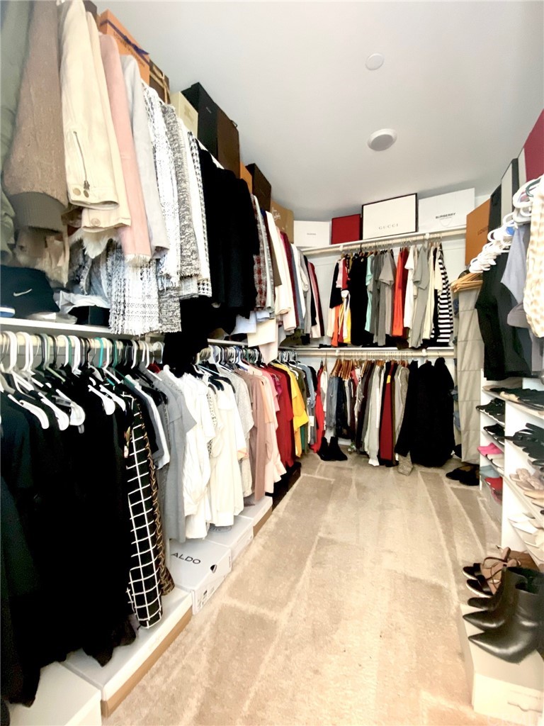 858 Blue Orchid Beaumont, CA 92223 - Photo 24 of 33 a view of walk in closet with clothes and shoes