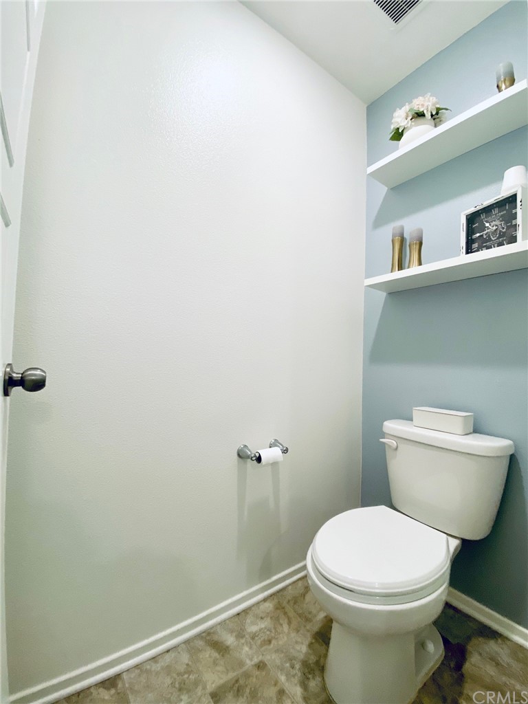 858 Blue Orchid Beaumont, CA 92223 - Photo 25 of 33 a white toilet sitting next to a bathroom sink