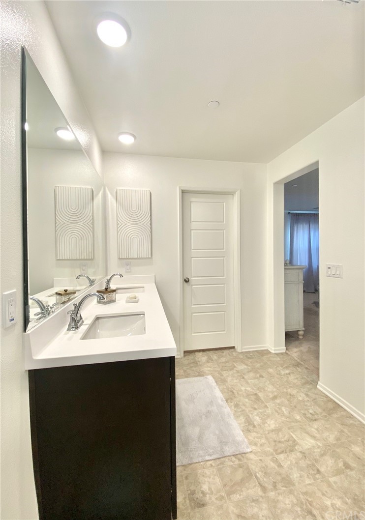 858 Blue Orchid Beaumont, CA 92223 - Photo 26 of 33 a bathroom with a sink double vanity and a mirror