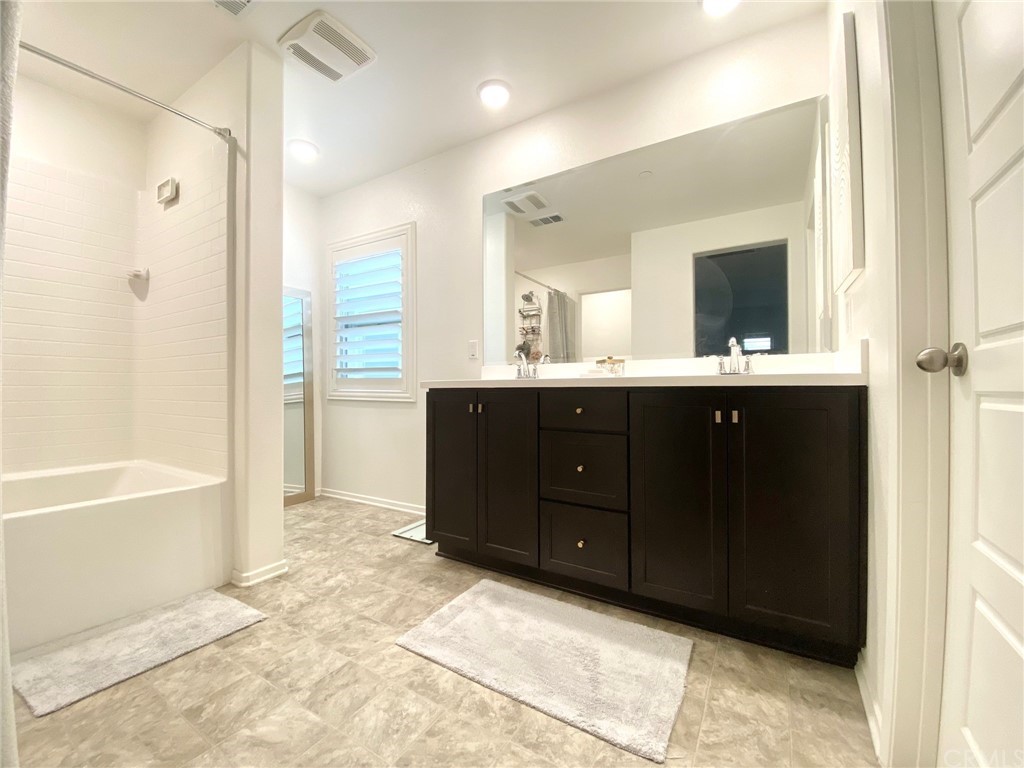858 Blue Orchid Beaumont, CA 92223 - Photo 27 of 33 a spacious bathroom with a tub sink shower and mirror