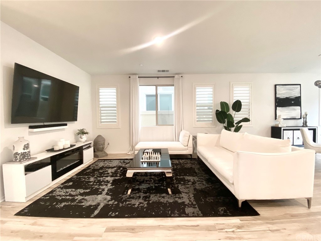 858 Blue Orchid Beaumont, CA 92223 - Photo 4 of 33 a living room with furniture and a flat screen tv