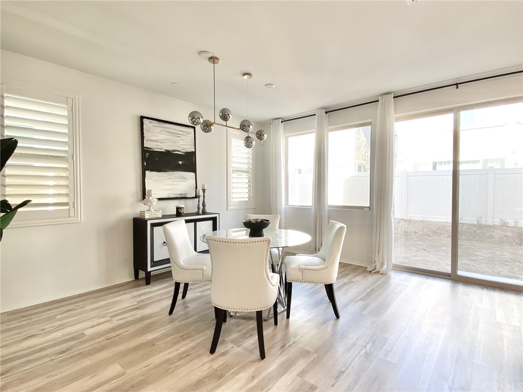 858 Blue Orchid Beaumont, CA 92223 - Photo 5 of 33 a view of a dining room with furniture window and wooden floor