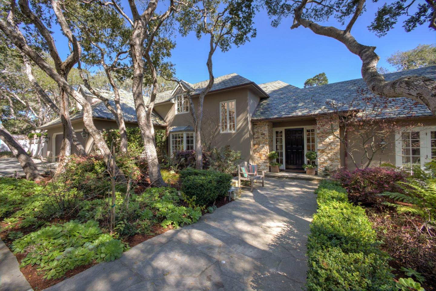 a front view of a house with garden