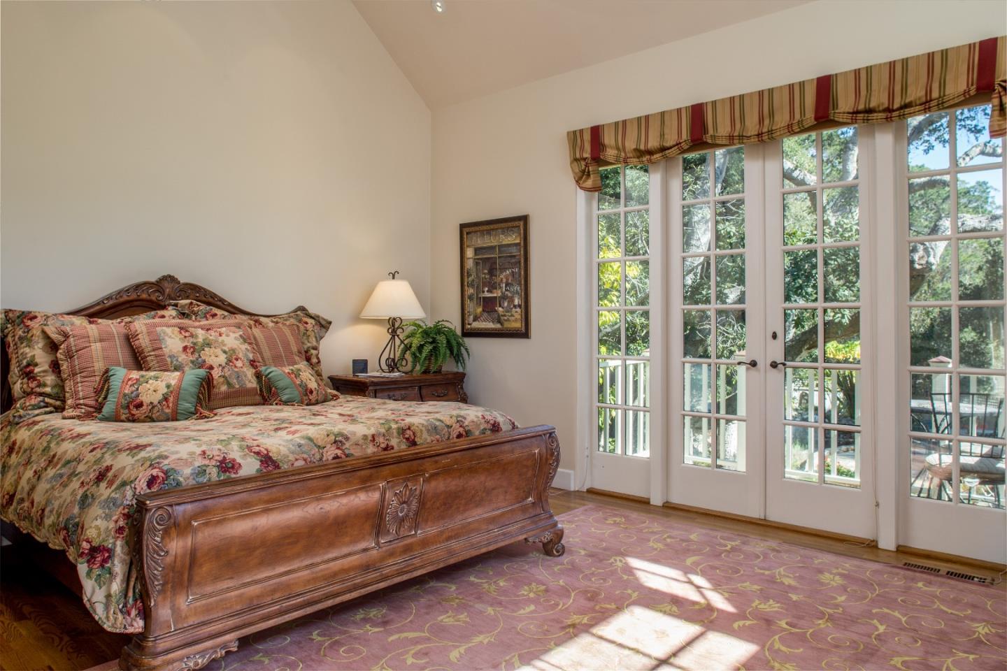 25951 Ridgewood Road Carmel, CA 93923 - Photo 15 of 23 a spacious bedroom with a bed and a large window