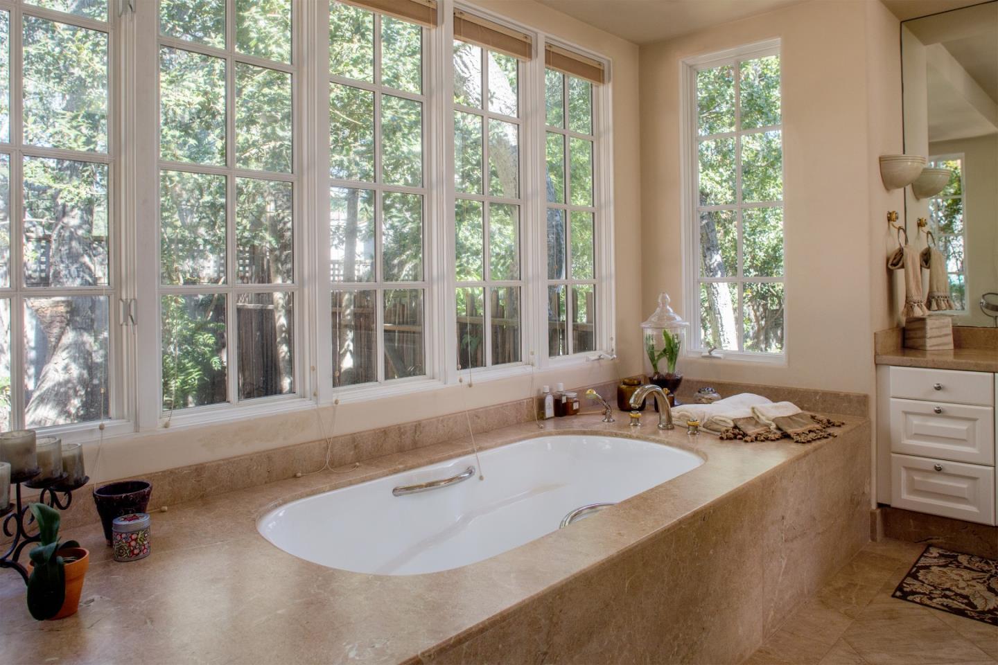 25951 Ridgewood Road Carmel, CA 93923 - Photo 16 of 23 a bathroom with a tub double vanity and window
