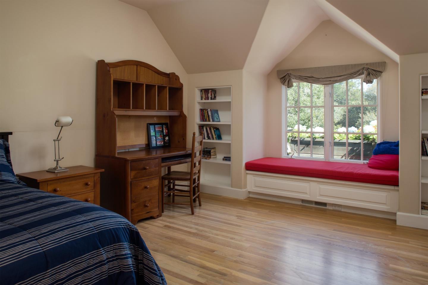 25951 Ridgewood Road Carmel, CA 93923 - Photo 19 of 23 a bedroom with furniture and a book shelf