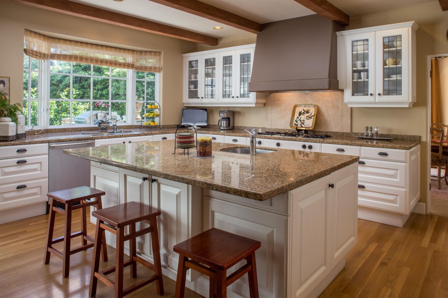 25951 Ridgewood Road Carmel, CA 93923 - Photo 10 of 23 a kitchen with stainless steel appliances granite countertop a stove a sink dishwasher and cabinets with wooden floor