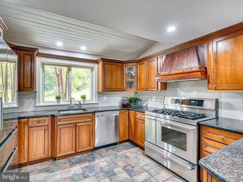 19701 Old York Road White Hall, MD 21161 - Photo 6 of 17 a kitchen with stainless steel appliances granite countertop wooden cabinets a sink and a stove