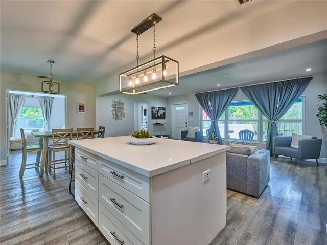 a view of living room kitchen with a table and chairs