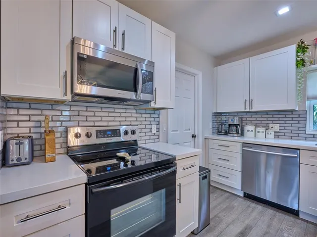 a kitchen with a sink cabinets and window