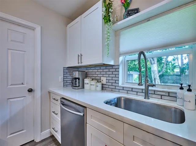 a kitchen with a sink and a window