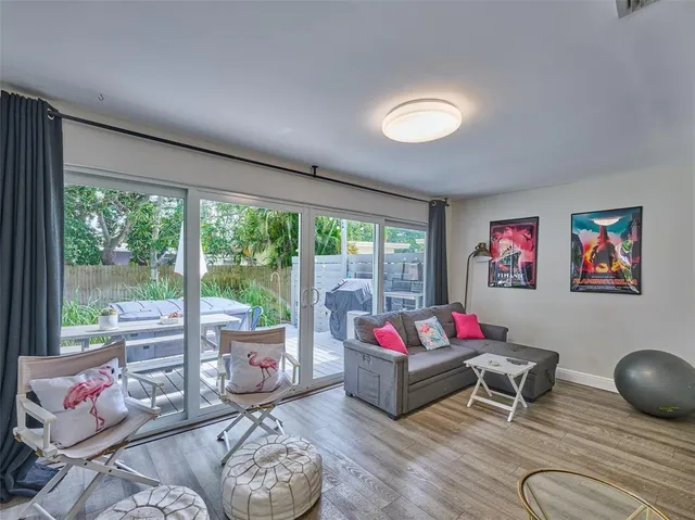 a bedroom with a bed and large windows