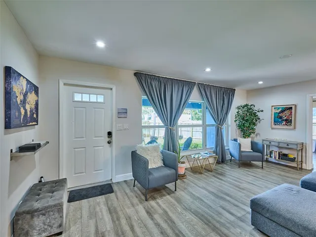 a living room with furniture and a large window