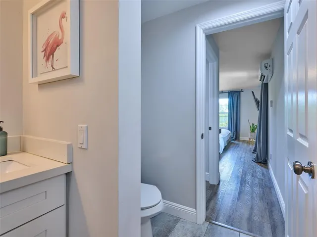 a view of a house with a yard and potted plants