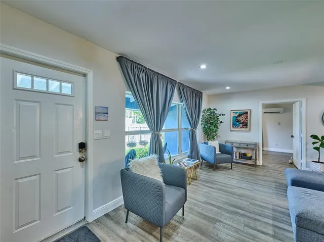 a living room with furniture window and wooden floor