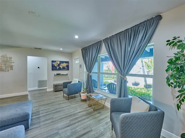 a living room with furniture and a large window