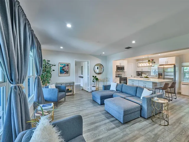 a living room with furniture and a large window