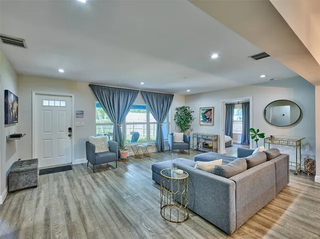 a living room with furniture and a large window