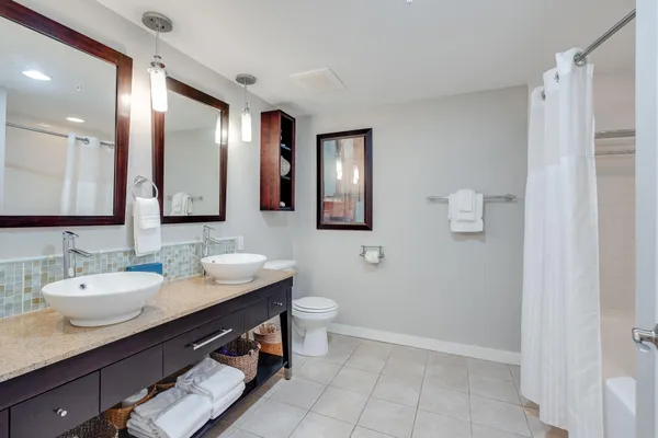a bathroom with a double vanity sink and a mirror