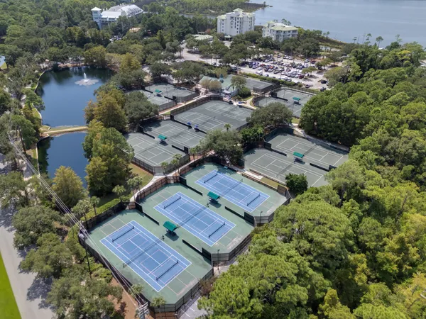an aerial view of a house with outdoor space and lake view