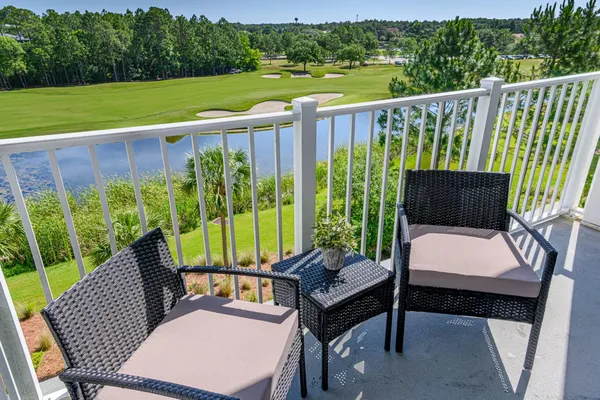 a view of a patio with a table chairs and a backyard