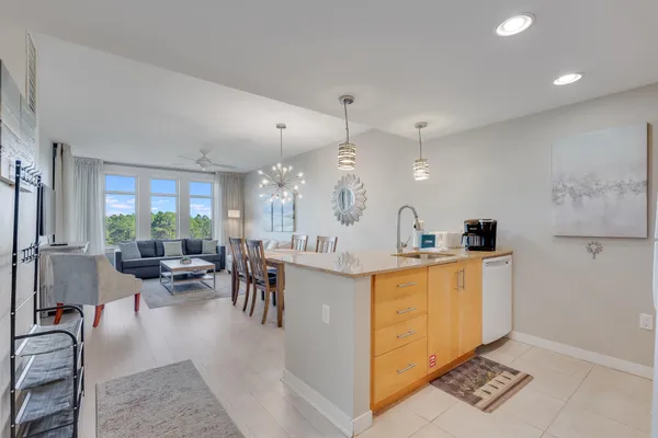 a large white kitchen with lots of counter space and windows
