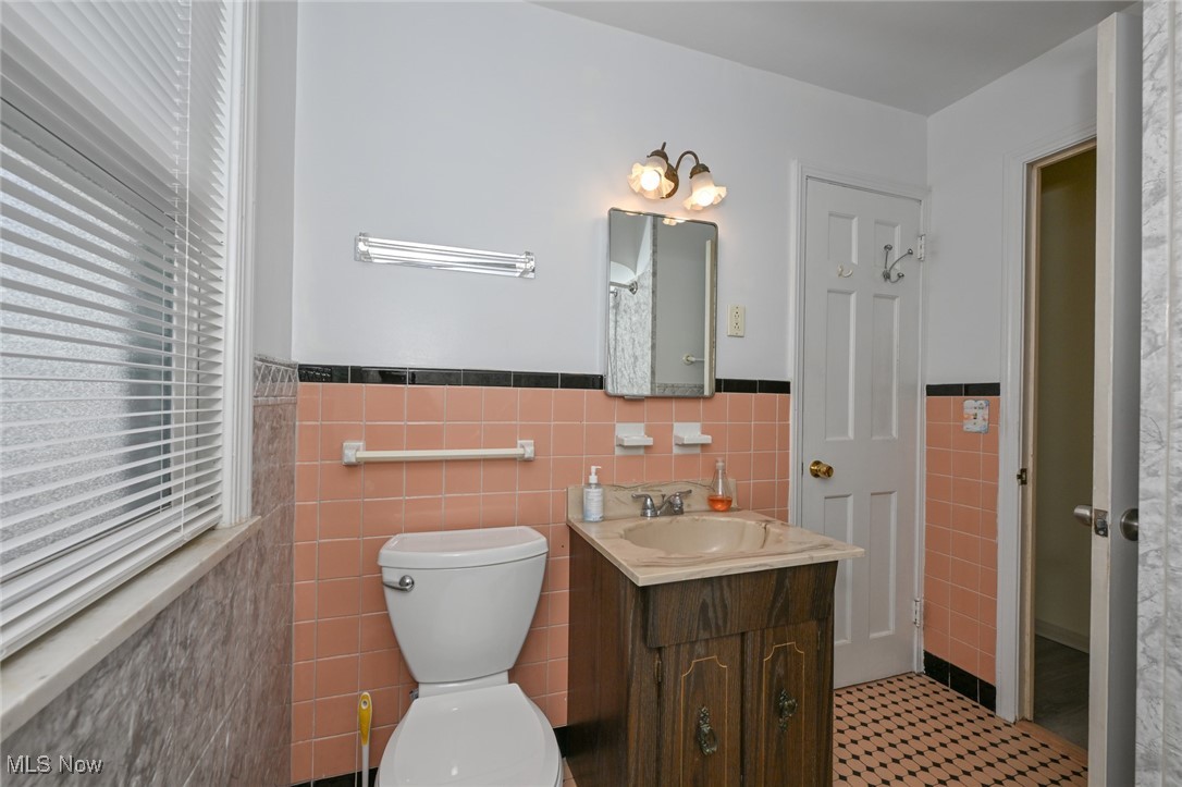 4033 Wyncote Road South Euclid, OH 44121 - Photo 11 of 25 Bathroom featuring tile walls, toilet, vanity, and tile patterned floors