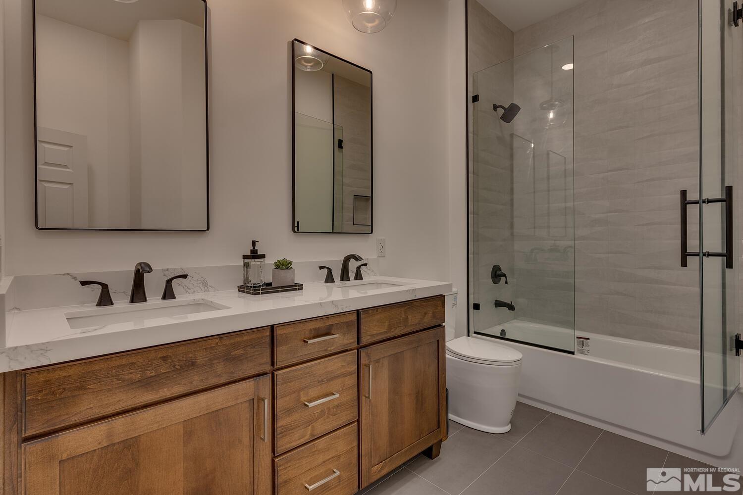 6109 Mesa Road Reno, NV 89511 - Photo 21 of 40 a bathroom with a double vanity sink toilet mirror and bathtub