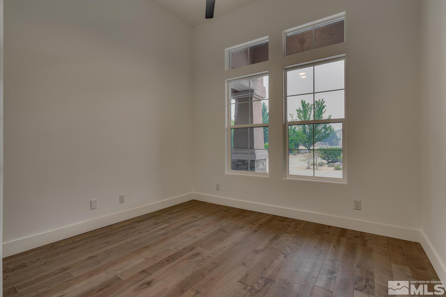 6109 Mesa Road Reno, NV 89511 - Photo 23 of 40 an empty room with wooden floor and windows
