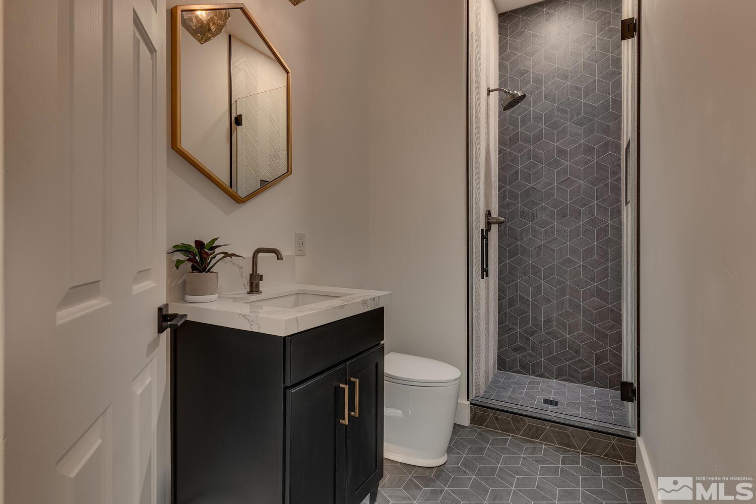 6109 Mesa Road Reno, NV 89511 - Photo 24 of 40 a bathroom with a granite countertop sink a toilet and shower