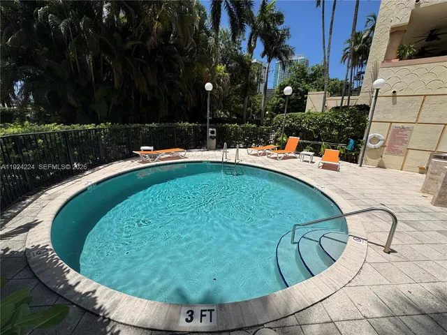 a swimming pool with outdoor seating and garden