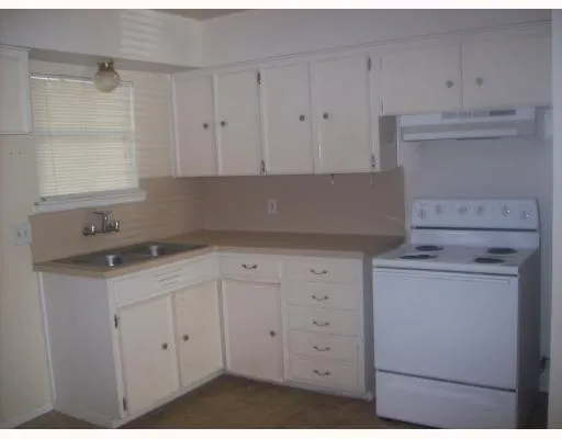 a kitchen with cabinets appliances