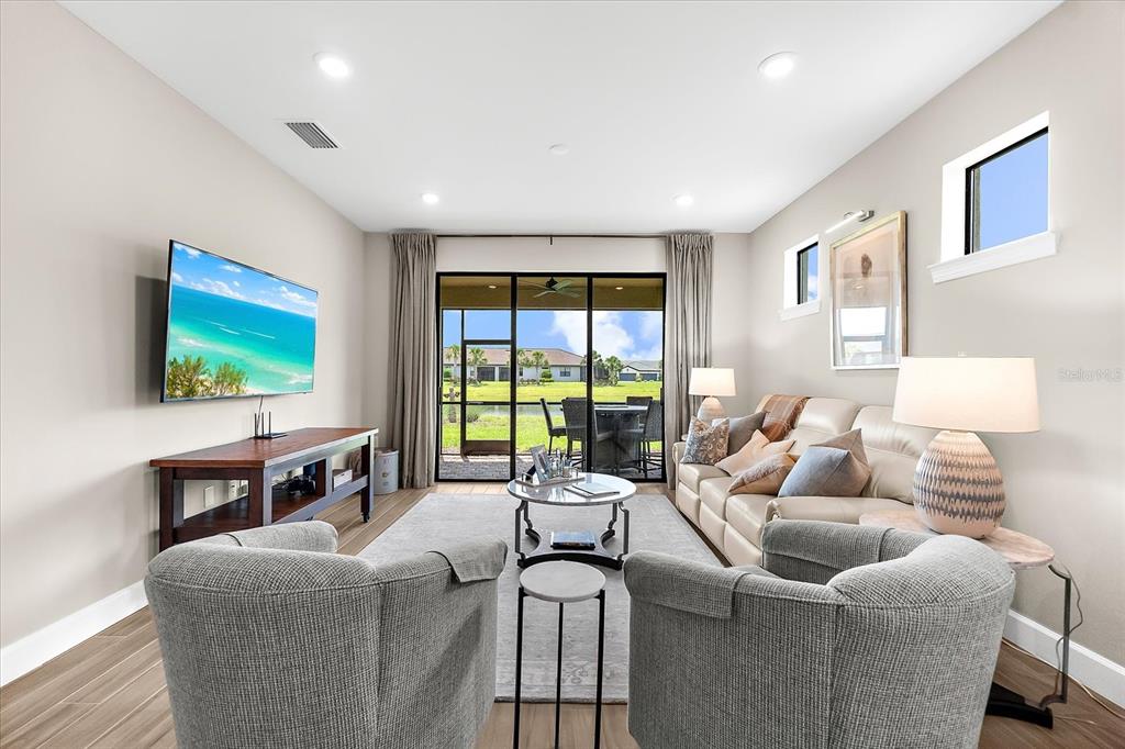6791 Alstead Circle Lakewood Ranch, FL 34202 - Photo 3 of 25 a living room with furniture and a flat screen tv