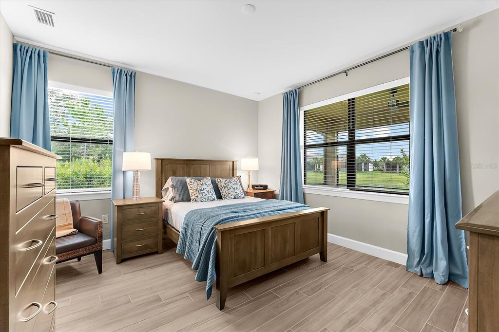 6791 Alstead Circle Lakewood Ranch, FL 34202 - Photo 4 of 25 a bedroom with a bed and a large window