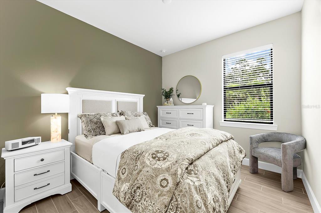 6791 Alstead Circle Lakewood Ranch, FL 34202 - Photo 5 of 25 a bedroom with a bed and a couch