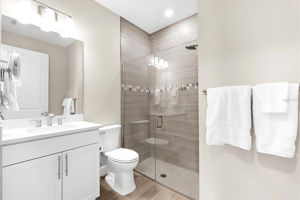 6791 Alstead Circle Lakewood Ranch, FL 34202 - Photo 7 of 25 a bathroom with a shower sink vanity mirror and toilet