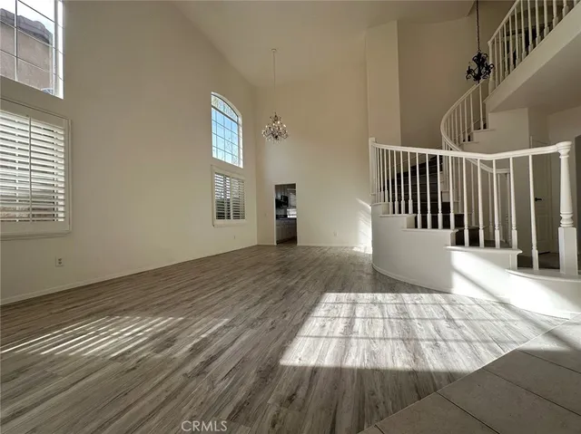 a view of a room with wooden floor