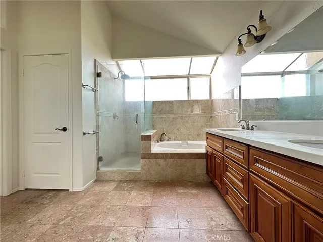 a bathroom with a tub sink and mirror