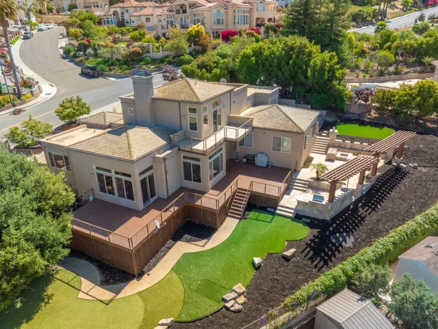an aerial view of a house with a garden and swimming pool