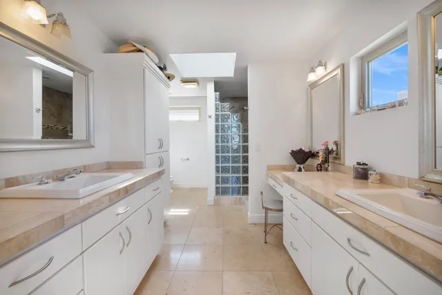 a spacious bathroom with a granite countertop sink mirror and double