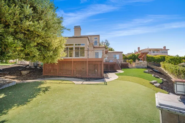 a view of a house with a swimming pool and sitting area