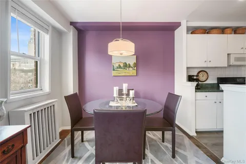 a view of a dining room with furniture and chandelier
