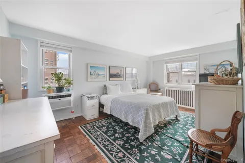 a spacious bedroom with a bed and a table in it